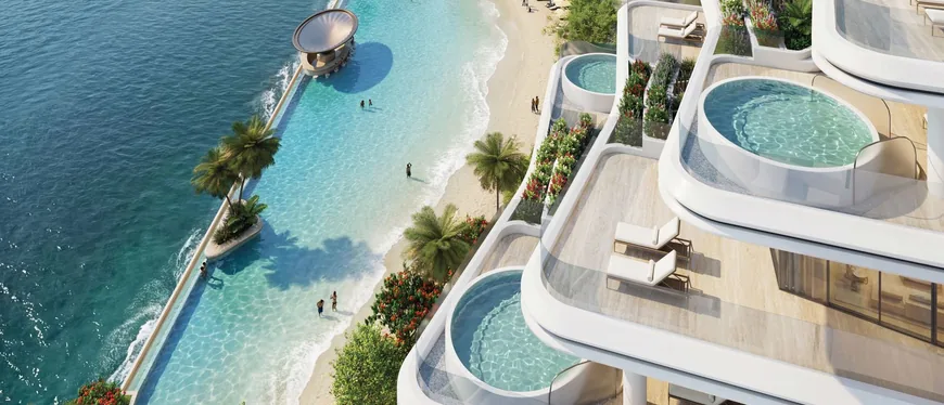 Swimmable lagoon and beach at Sobha City, edged by terraced residences with private pools